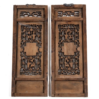 Lot 384 - A pair of Oriental hardwood carved panels.