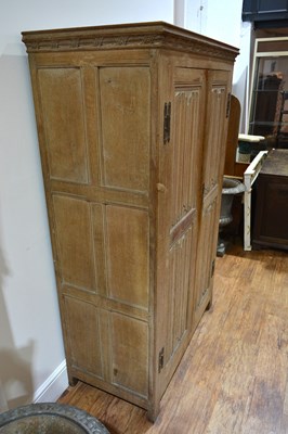 Lot 65 - Limed oak linen fold cupboard with iron hinges...