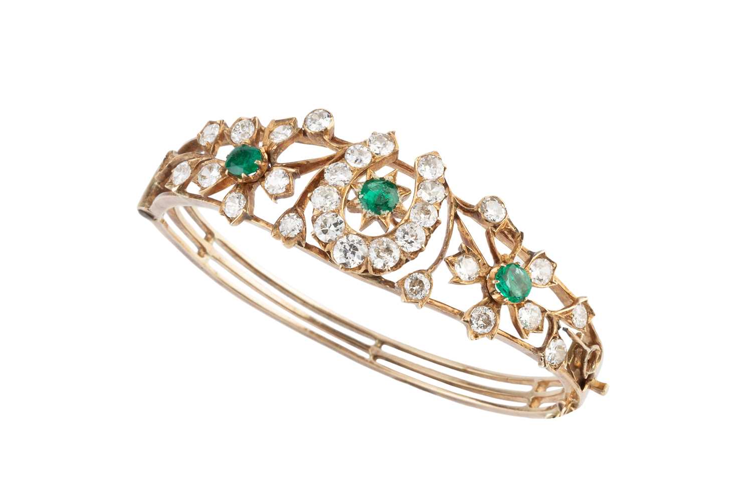 Lot 96 - An emerald and diamond bangle, of hinged oval...