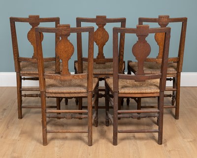 Lot 1110 - A set of five antique French country-made oak kitchen chairs