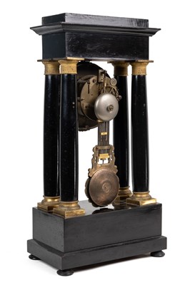 Lot 260 - A 19th century French Empire Portico mantel clock