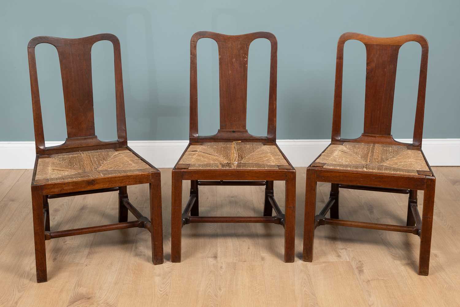 Lot 1302 - A group of three George II walnut dining chairs