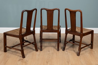Lot 1302 - A group of three George II walnut dining chairs
