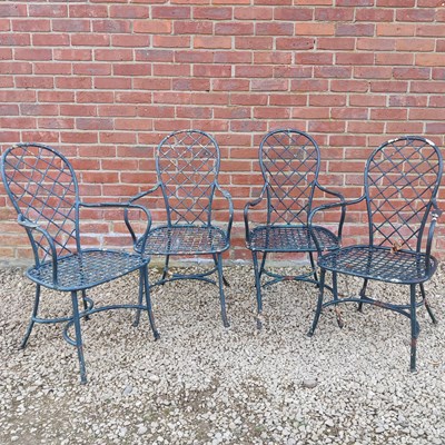 Lot 1499 - A set of four French green-painted garden open armchairs