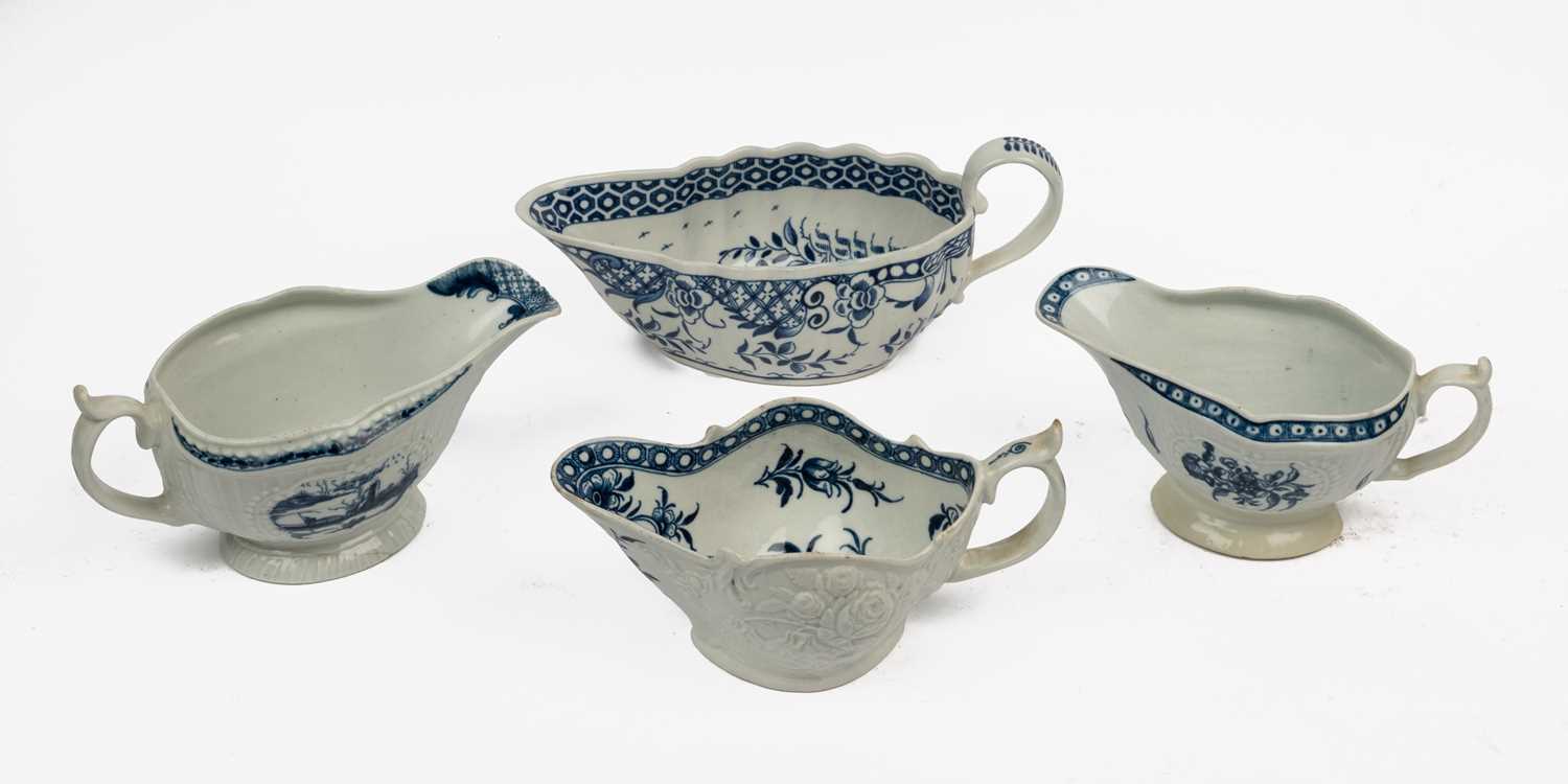 Lot 1335 - A group of four 18th century blue and white porcelain gravy boats