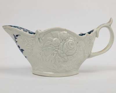 Lot 1335 - A group of four 18th century blue and white porcelain gravy boats