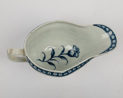 Lot 1335 - A group of four 18th century blue and white porcelain gravy boats