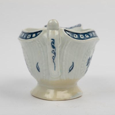 Lot 1335 - A group of four 18th century blue and white porcelain gravy boats