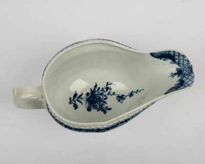 Lot 1335 - A group of four 18th century blue and white porcelain gravy boats