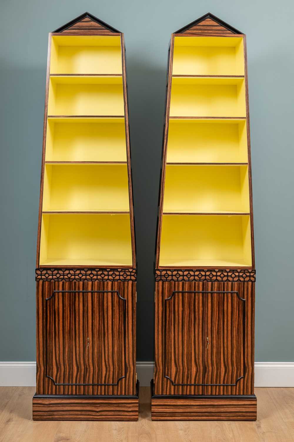 Lot 528 - A pair of Coromandel pyramid bookcases