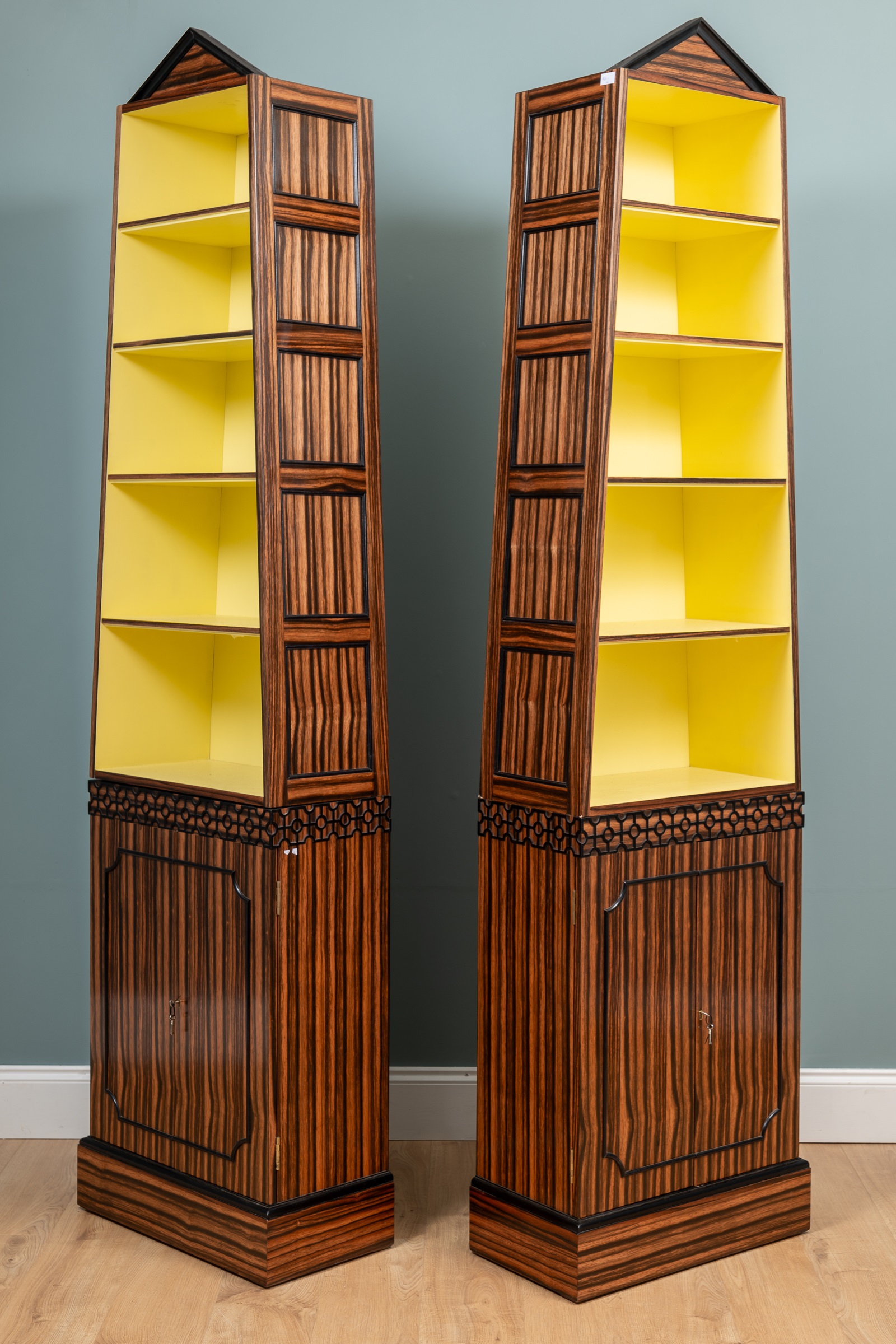 Lot 528 - A pair of Coromandel pyramid bookcases