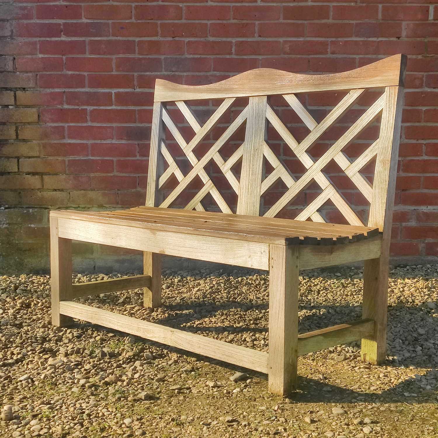 Lot 1514 - A teak garden bench by Charles Verey