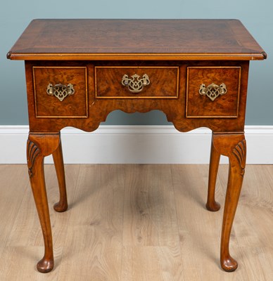 Lot 1034 - A George III-style walnut lowboy