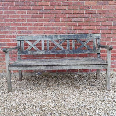 Lot 1451 - A teak three-seater garden bench