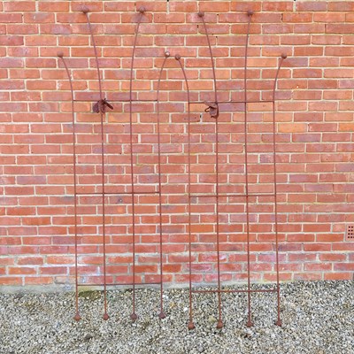 Lot 1519 - A pair of hand-forged wrought iron honeysuckle plant supports