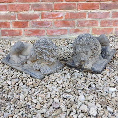 Lot 1472 - A pair of cast reconstituted stone recumbent lions
