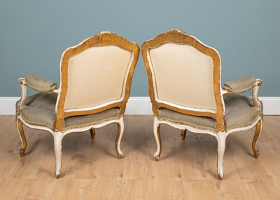 Lot 517 - A pair of 19th century English parcel gilt, cream-painted open armchairs