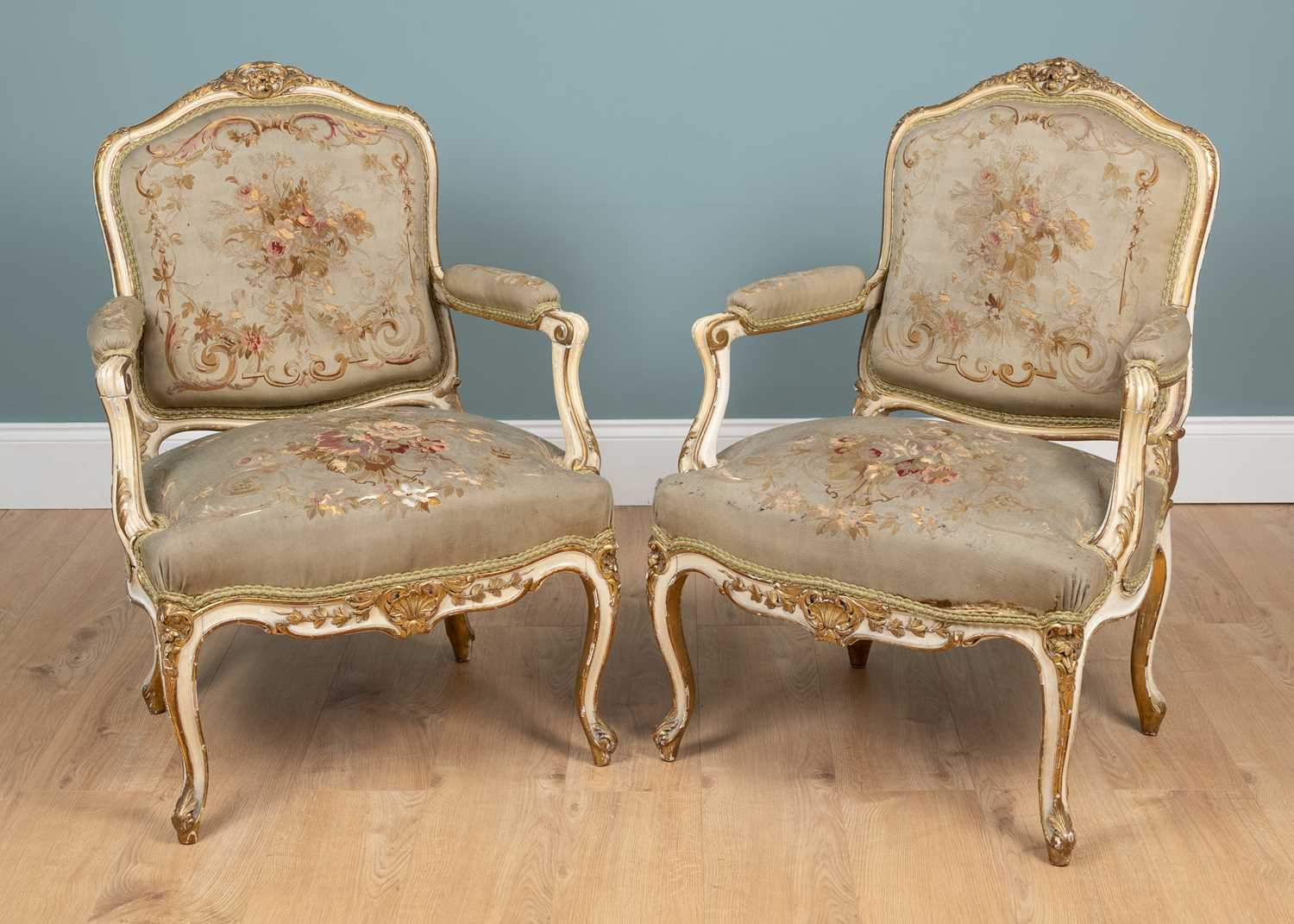 Lot 517 - A pair of 19th century English parcel gilt, cream-painted open armchairs