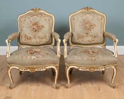Lot 517 - A pair of 19th century English parcel gilt, cream-painted open armchairs