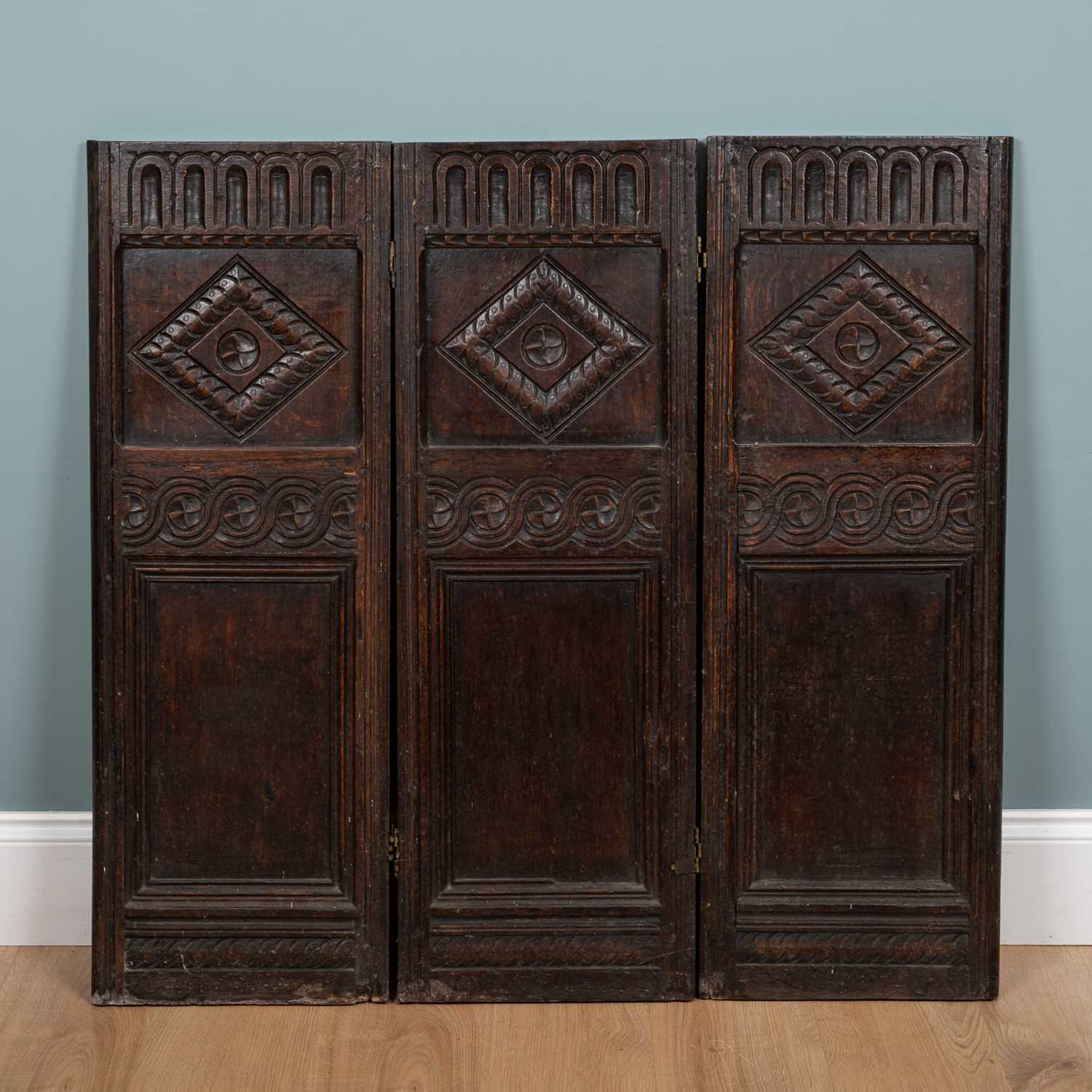 Lot 1033 - An 18th century oak three-fold screen