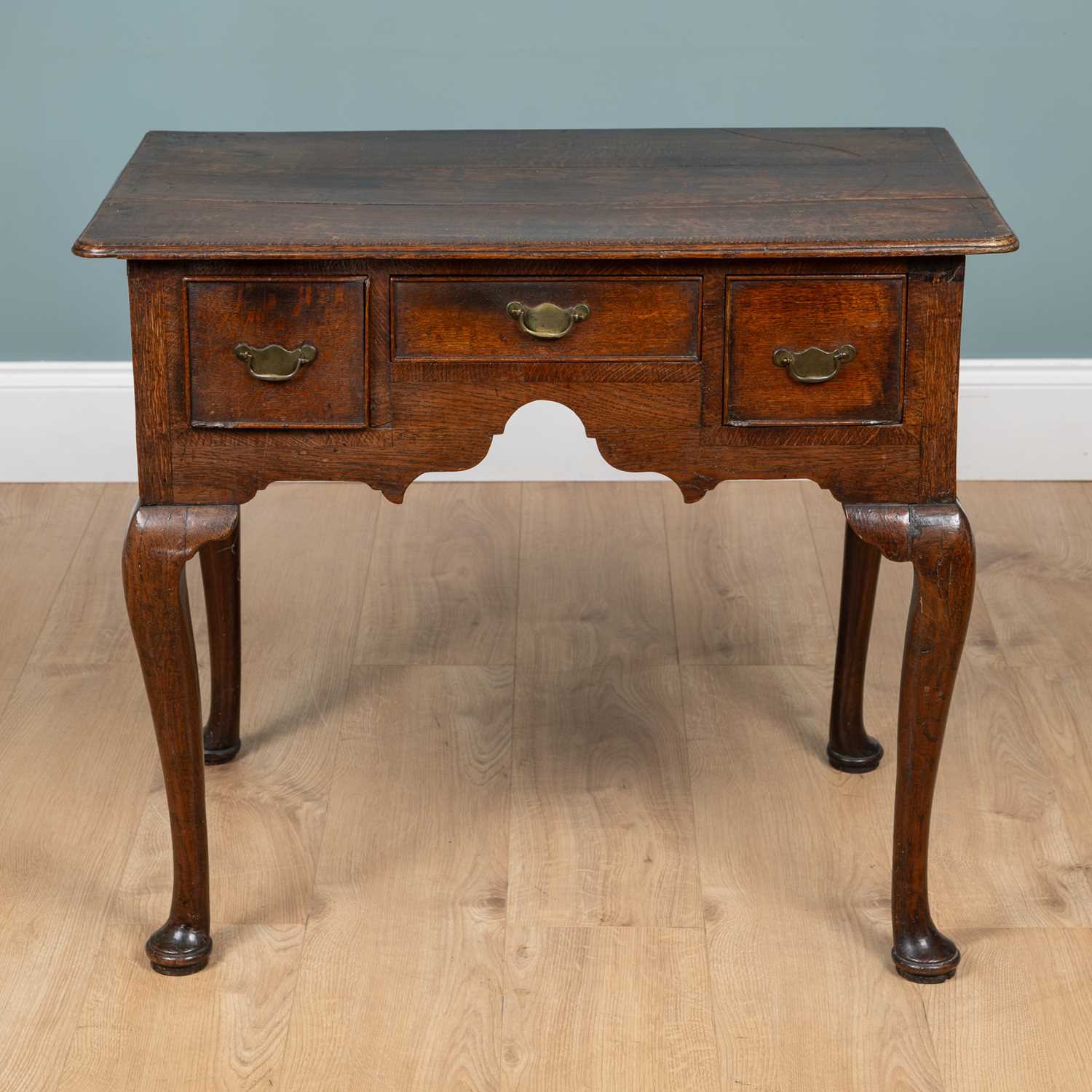 Lot 1072 - A Georgian oak lowboy