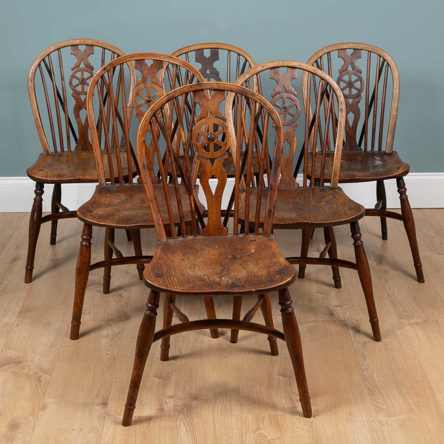 Lot 1057 - A harlequin set of six yew and elm Windsor chairs