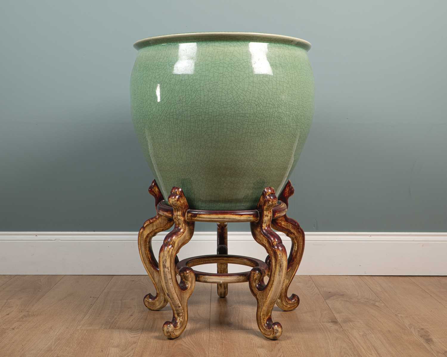 Lot 410 - A large Chinese celadon ceramic planter and wooden stand