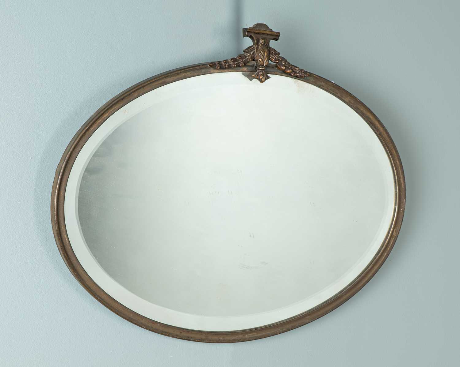 Lot 314 - A French Neoclassical brass-framed oval wall mirror