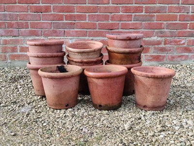 Lot 1502 - A collection of fourteen similar thrown terracotta pots