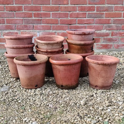 Lot 1502 - A collection of fourteen similar thrown terracotta pots