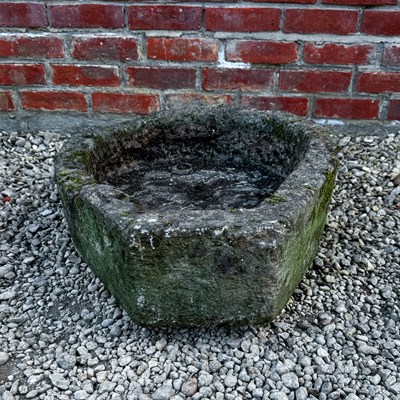 Lot 1504 - A carved stone horseshoe shaped trough