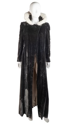 Lot 363 - A long-sleeved cape in black velvet with pale...