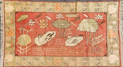 Lot 1389 - An early 20th century hand woven Uyghur Chinese rug