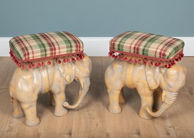 Lot 305 - Two carved wooden elephant stools