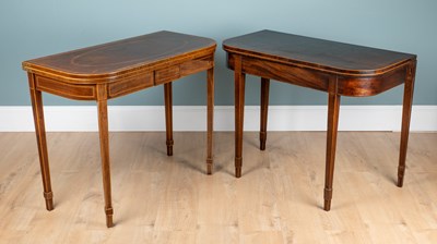 Lot 1105 - A George III mahogany D-end fold-over tea table and another similar