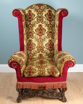 Lot A Carolean-style upholstered wing armchair
