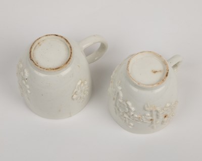 Lot 1362 - Two 18th century Bow porcelain blanc de chine prunus decorated coffee cups