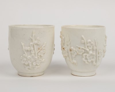 Lot 1362 - Two 18th century Bow porcelain blanc de chine prunus decorated coffee cups