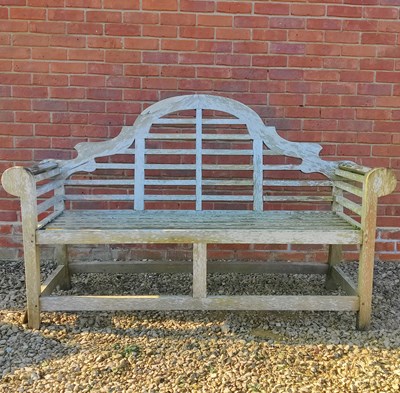 Lot 1517 - A Lutyens-style teak garden bench