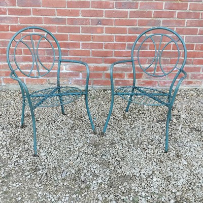 Lot 1543 - A pair of green painted tubular garden open armchairs