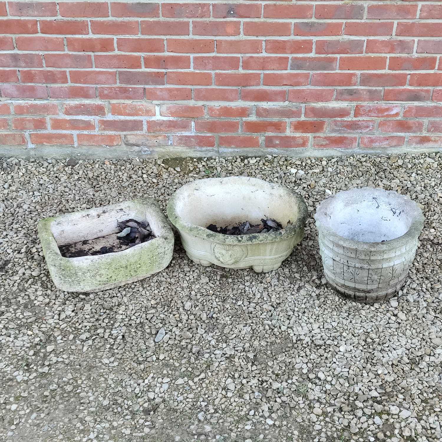 Lot 1524 - A small stone trough and two cast reconstituted stone planters
