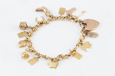 Lot 61 - A charm bracelet, the fancy-link bracelet with...