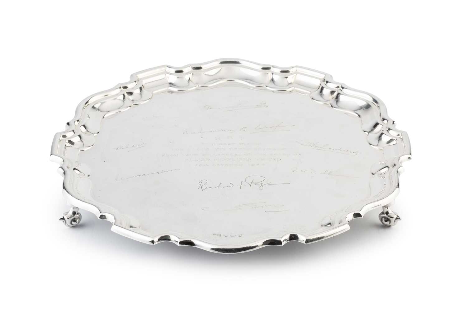 Lot 546 - A silver salver, with shaped border, engraved...
