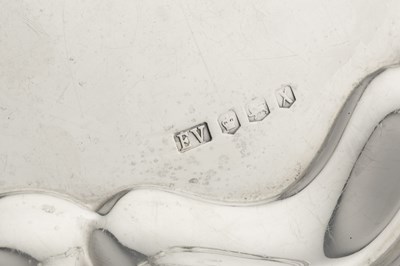 Lot 546 - A silver salver, with shaped border, engraved...
