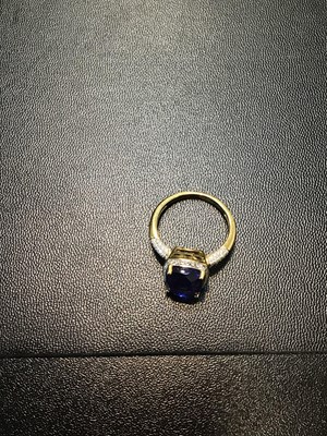 Lot 106 - A tanzanite and diamond cluster ring, the...