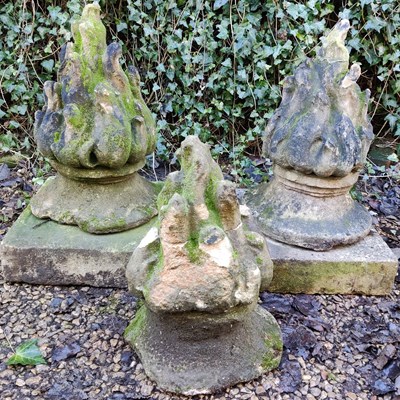 Lot 1489 - Three cast composite flaming finials