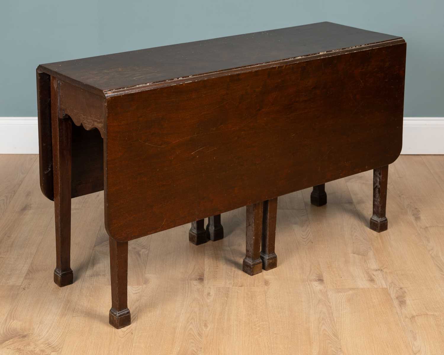 Lot 554 - A George III Irish mahogany drop-leaf dining table