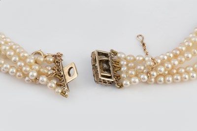 Lot 129 - A multi-strand pearl necklace with diamond set...