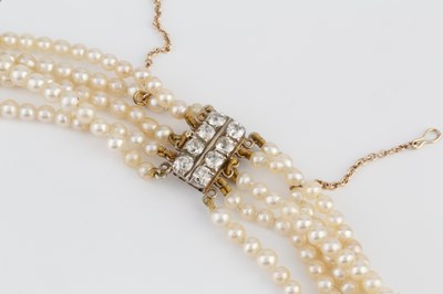 Lot 129 - A multi-strand pearl necklace with diamond set...