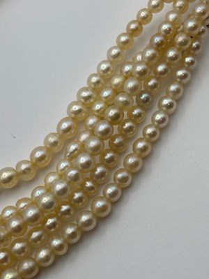 Lot 129 - A multi-strand pearl necklace with diamond set...